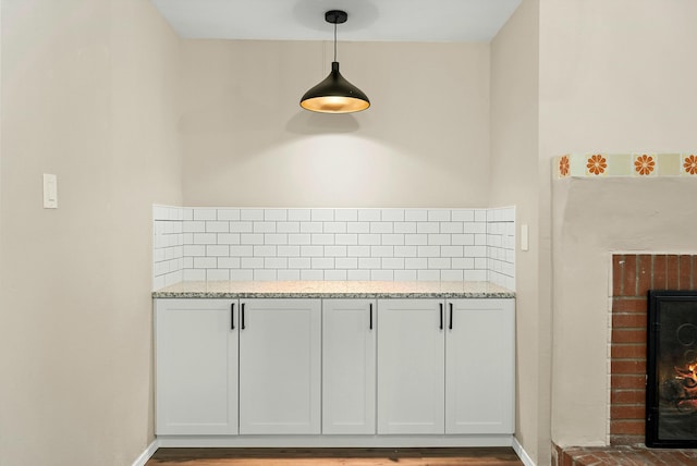 interior space with a brick fireplace and baseboards