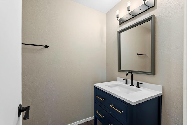 bathroom featuring baseboards and vanity