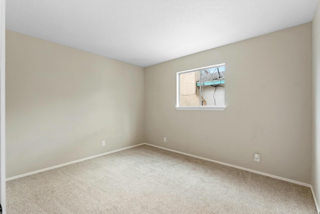 carpeted spare room with baseboards