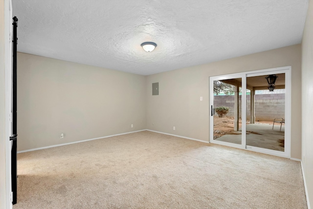 spare room featuring carpet, electric panel, and baseboards