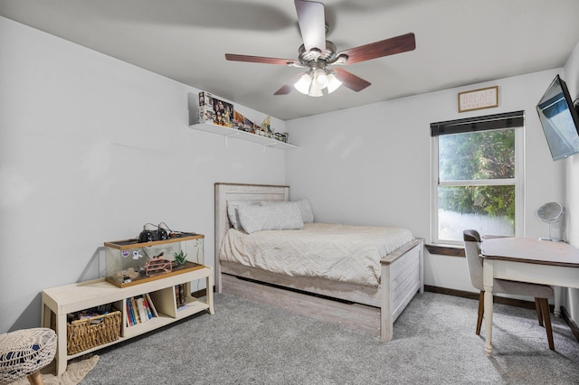 bedroom with a ceiling fan, baseboards, and carpet floors