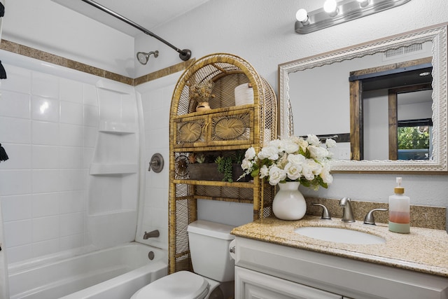 full bath with vanity, toilet, shower / bathtub combination, and a textured wall