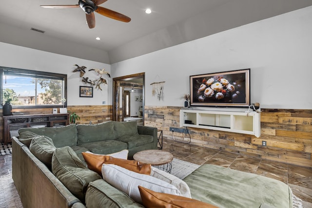 living room featuring a wainscoted wall, visible vents, recessed lighting, ceiling fan, and wood walls