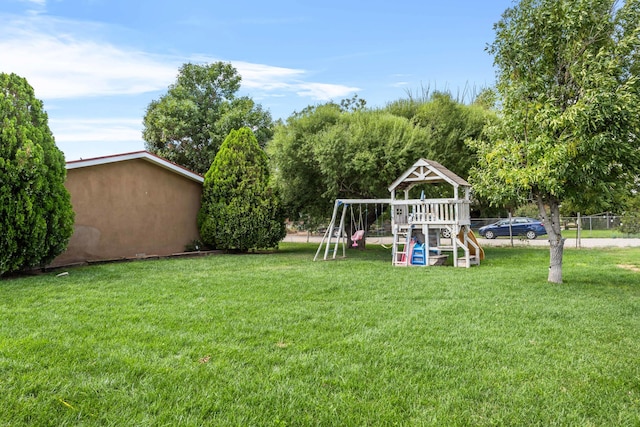 view of yard featuring fence and a playground