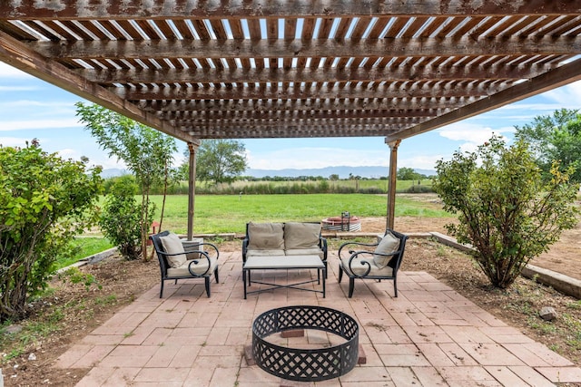 view of patio with outdoor lounge area and a rural view