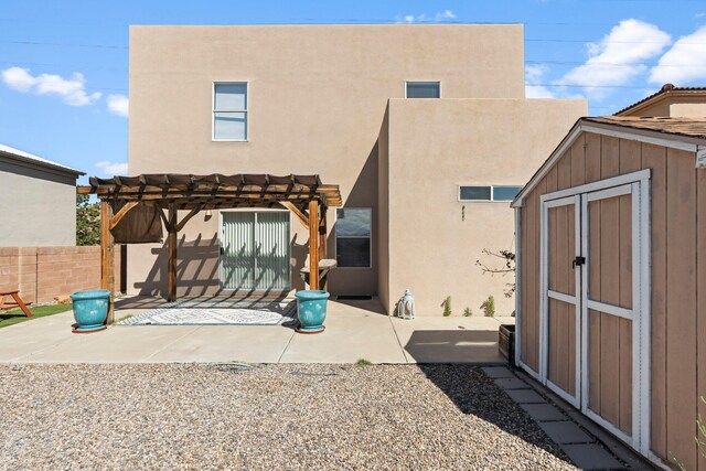 8104 Sleeping Bear Dr NW, Albuquerque, NM 87120 - rear view of house with a patio area, a shed, a pergola, and stucco siding