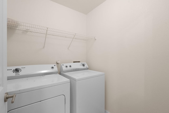 washroom with laundry area and washer and clothes dryer