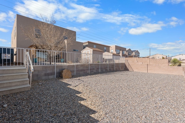 view of yard with a residential view and a fenced backyard