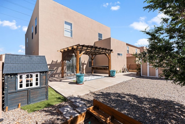 8104 Sleeping Bear Dr NW, Albuquerque, NM 87120 - back of property featuring a shed, stucco siding, a pergola, and a patio