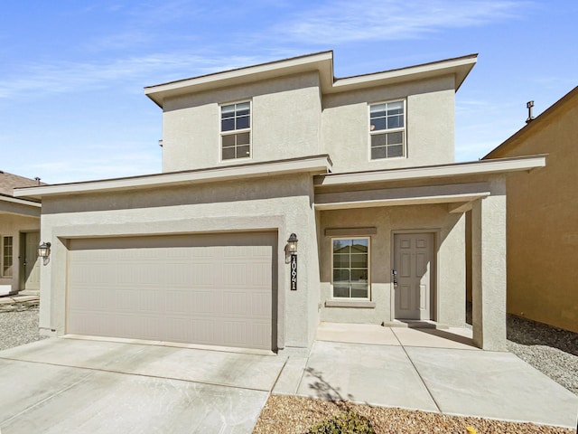 view of front of house featuring concrete driveway and stucco siding