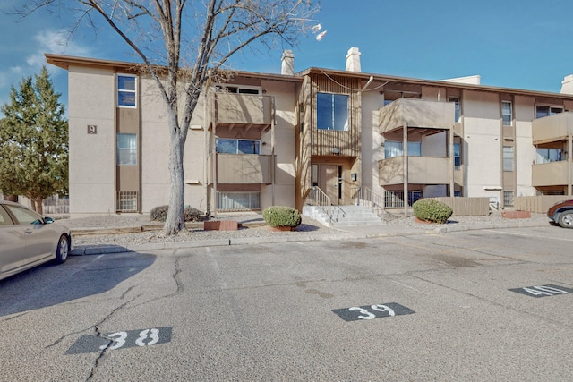 view of property featuring uncovered parking