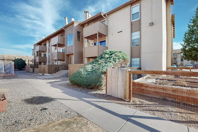 view of building exterior featuring fence