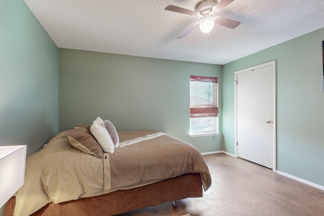 bedroom with a textured ceiling, a ceiling fan, and baseboards