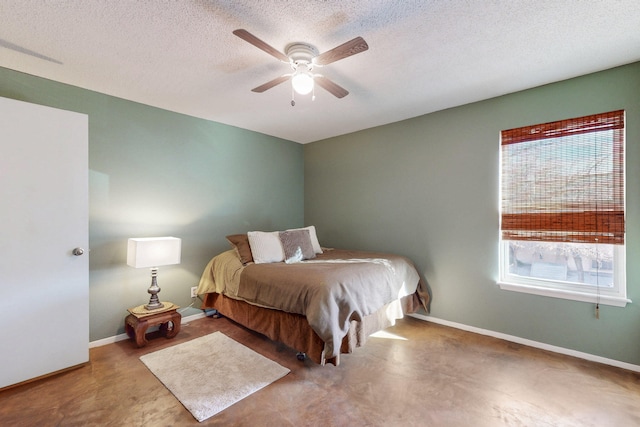 bedroom featuring a textured ceiling, a ceiling fan, and baseboards