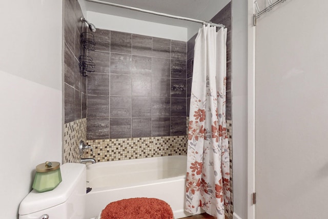 bathroom with shower / bath combination with curtain and toilet