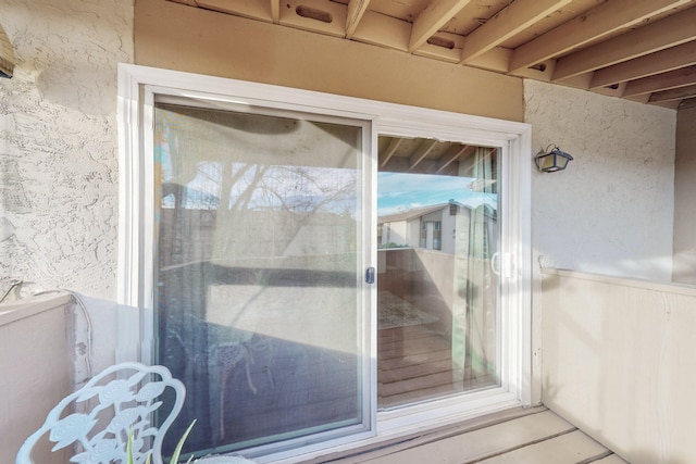 entrance to property with stucco siding