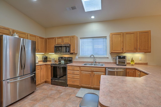 kitchen featuring light tile patterned floors, a sink, visible vents, light countertops, and appliances with stainless steel finishes