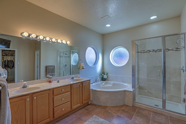 full bathroom with visible vents, a sink, a bath, and a shower stall