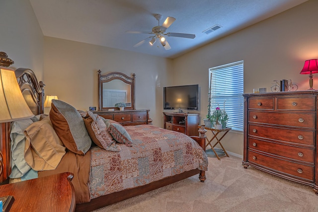 bedroom featuring visible vents, baseboards, light colored carpet, lofted ceiling, and ceiling fan