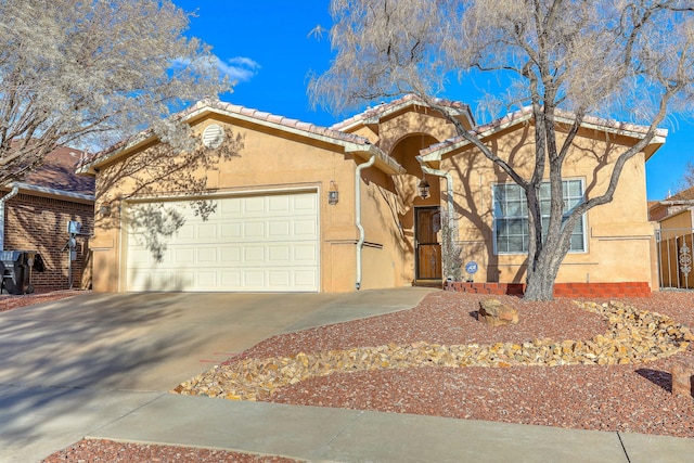 single story home featuring an attached garage, a tile roof, concrete driveway, and stucco siding