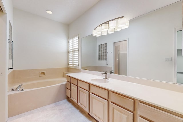 full bathroom featuring tile patterned flooring, a garden tub, vanity, and recessed lighting