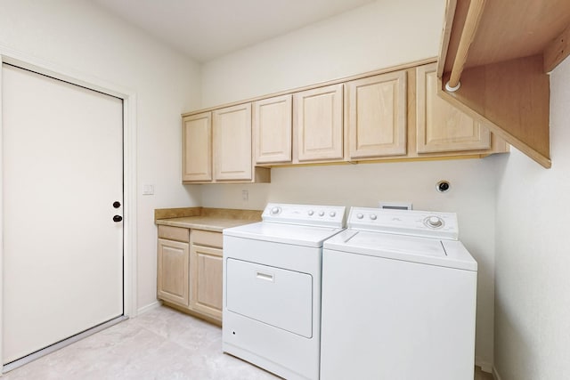 laundry room featuring cabinet space, baseboards, and separate washer and dryer