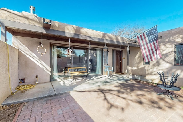 exterior space with a patio and stucco siding