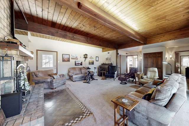 carpeted living area with tile patterned flooring, wood ceiling, a fireplace with raised hearth, and beamed ceiling