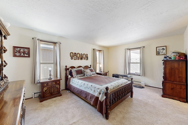 bedroom featuring light carpet, baseboard heating, and a textured ceiling