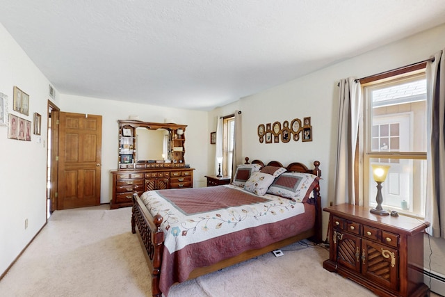 bedroom featuring light carpet, multiple windows, visible vents, and baseboard heating