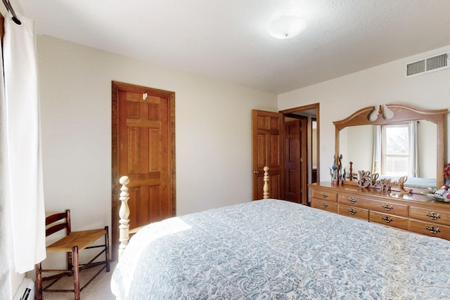 bedroom featuring a baseboard radiator and visible vents