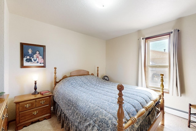 bedroom featuring light carpet and a baseboard heating unit