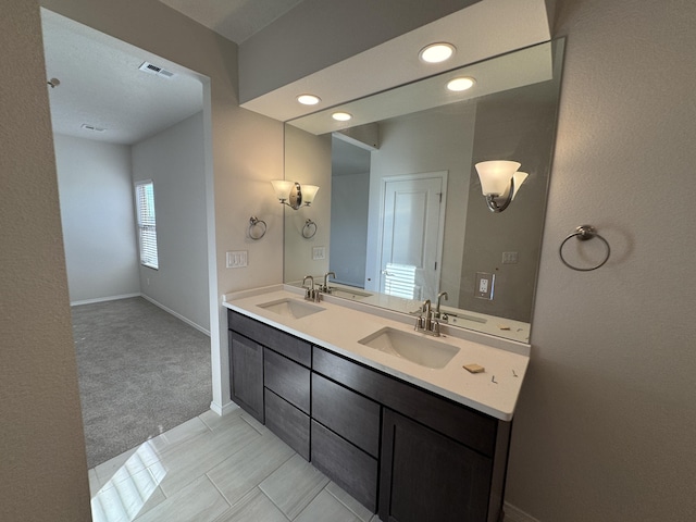bathroom with visible vents, recessed lighting, and a sink