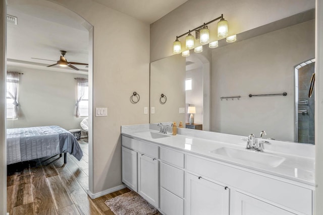 full bathroom featuring ensuite bath, wood finished floors, visible vents, and a sink