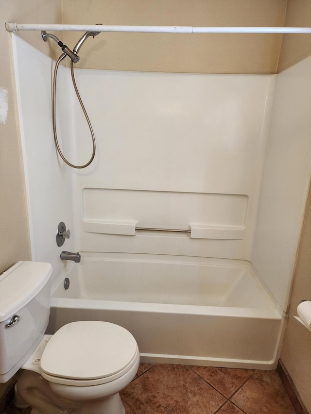 bathroom with tile patterned flooring, toilet, and washtub / shower combination