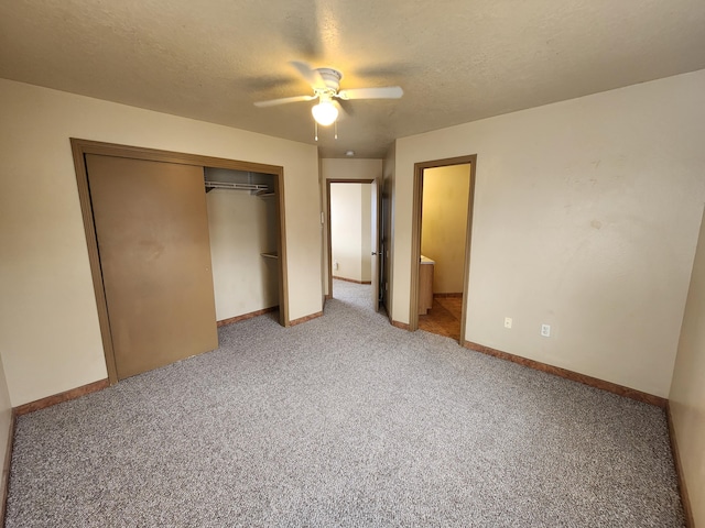 unfurnished bedroom with a textured ceiling, baseboards, ceiling fan, a closet, and light carpet