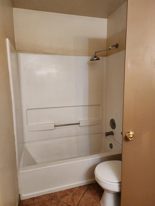 full bathroom with tile patterned flooring, a textured ceiling, toilet, and  shower combination