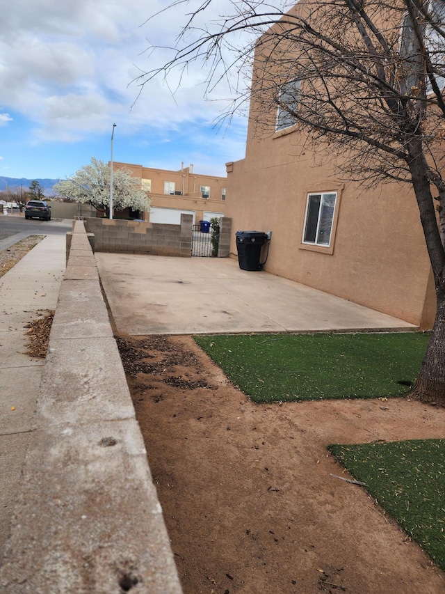 view of yard featuring a gate, a patio area, and fence