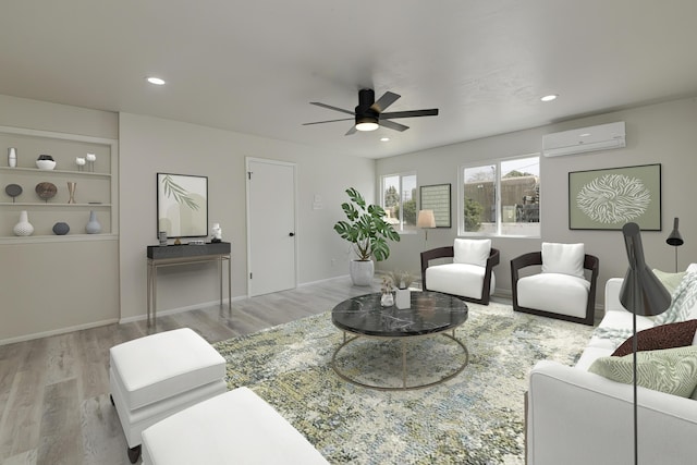 living area with recessed lighting, a ceiling fan, wood finished floors, and a wall mounted air conditioner