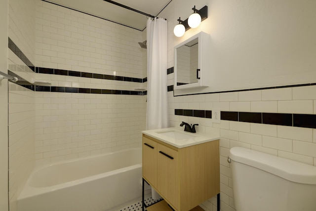 full bathroom with vanity, shower / bath combo with shower curtain, toilet, and tile walls