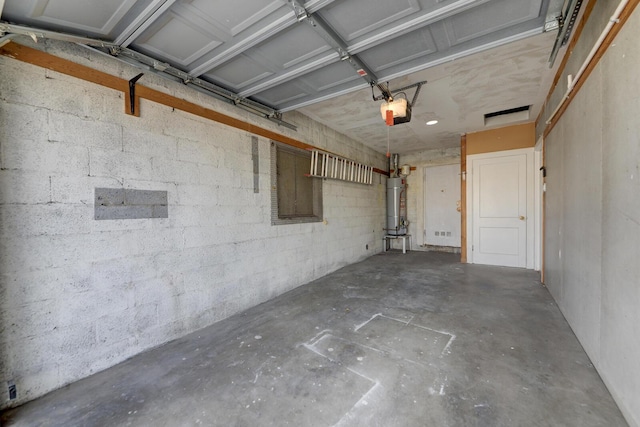 garage with a garage door opener and secured water heater