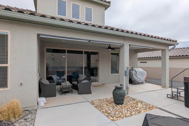 view of patio / terrace featuring a ceiling fan, a grill, and an outdoor living space