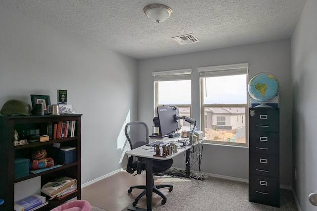 office area featuring a healthy amount of sunlight, baseboards, visible vents, and carpet flooring