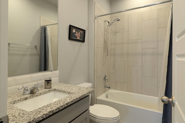 bathroom with vanity, toilet, and shower / bath combo with shower curtain