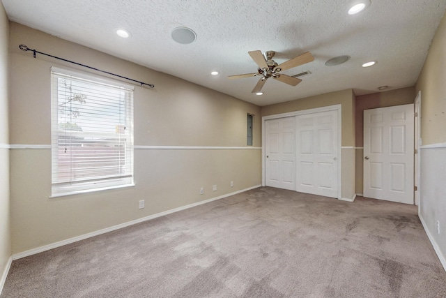 unfurnished bedroom featuring recessed lighting, carpet floors, visible vents, baseboards, and a closet