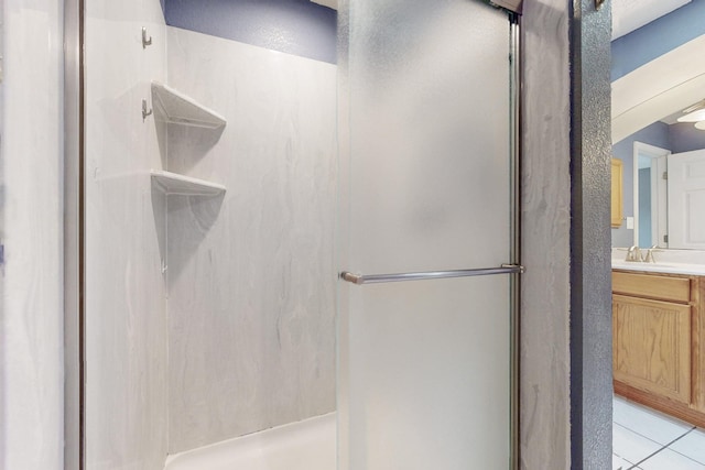 bathroom with a stall shower, vanity, and tile patterned floors