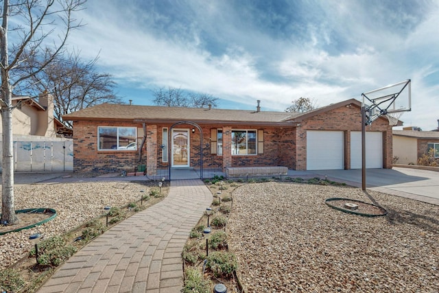 ranch-style house with a garage, covered porch, driveway, and brick siding