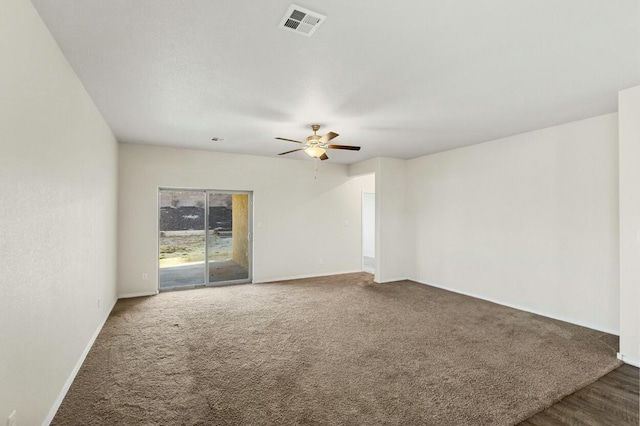 spare room featuring ceiling fan, carpet flooring, visible vents, and baseboards