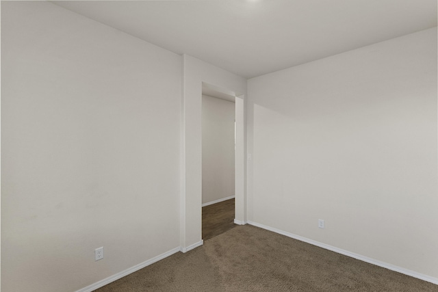 carpeted spare room with baseboards