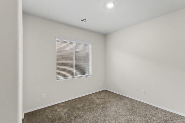 carpeted empty room with baseboards and visible vents